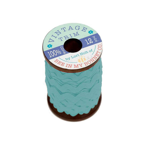 Image of the Vintage Trim Small Raindrop by Lori Holt for Riley Blake Designs. Features an aqua trim on a small wooden spool. 
Cute Little Fabric Shop
