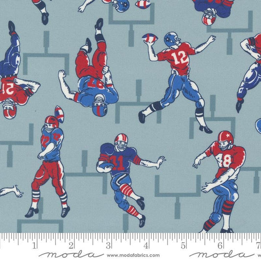 Image of the Play Ball Players Dolphin quilting cotton fabric by Moda Fabrics. Features novelty football players scattered on a blue background. 
Cute Little Fabric Shop