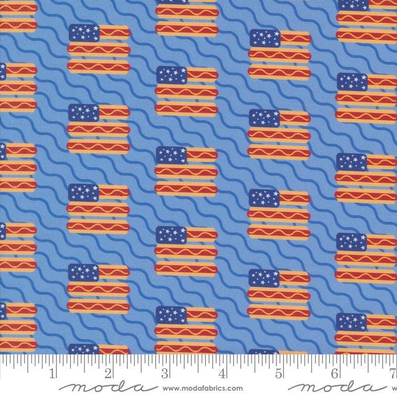 Image of the Play Ball Flags Sky quilting cotton fabric by Moda Fabrics. Features novelty flags and hotdogs on a sky background. 
Cute Little Fabric Shop