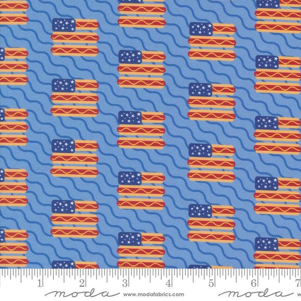 Image of the Play Ball Flags Sky quilting cotton fabric by Moda Fabrics. Features novelty flags and hotdogs on a sky background. 
Cute Little Fabric Shop