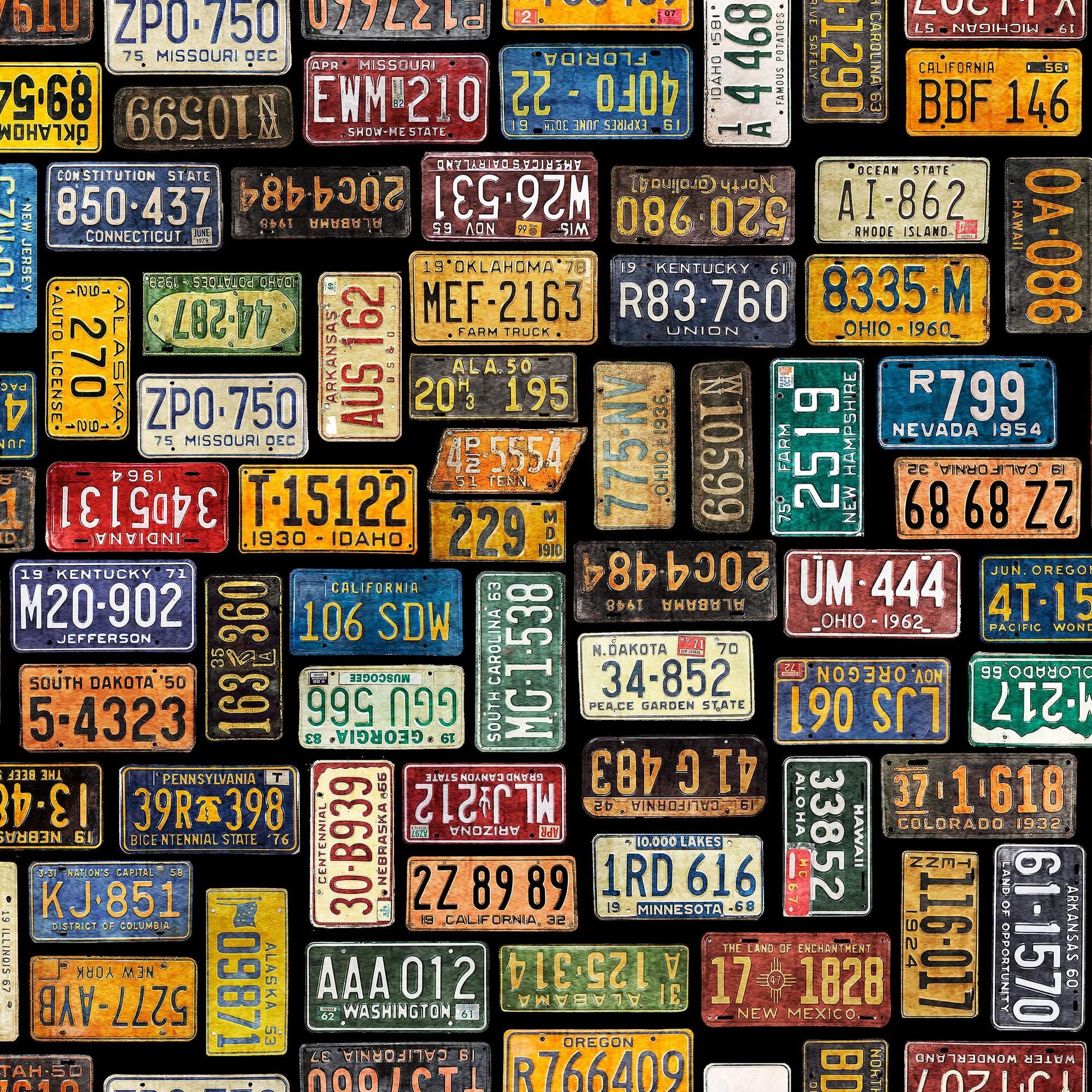 Image of the Heavy Metal License Plates Black J quilting cotton fabric by Morris Creative Group for QT Fabrics. Features small license plates on a black background. 
Cute Little Fabric Shop