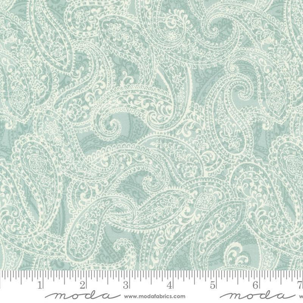 Image of the Sandalwood Adeline Eucalyptus quilting cotton fabric by 3 Sisters for Moda Fabrics. Features a floral fabric on a blue background. Cute Little Fabric Shop
