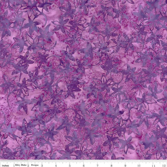 Image of the Expressions Batiks Bedazzled! Grape Soda quilting cotton fabric by Pat Fryer for Riley Blake Designs. Features a flower star pattern on a purple background. 
Cute Little Fabric Shop