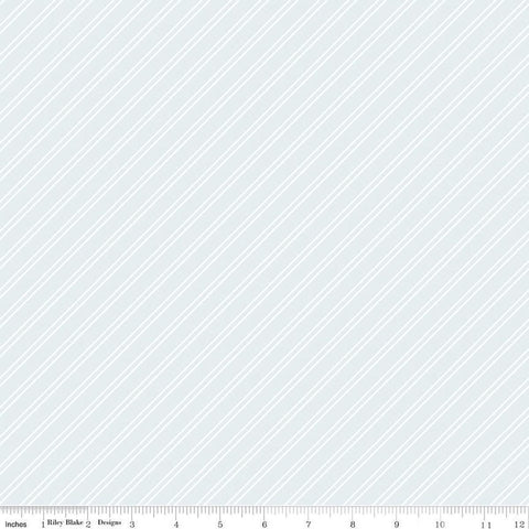Image of the Between the Pages Stripes Iceberg quilting cotton fabric by Fran Gulick for Riley Blake Designs. Features diagonal small stripes on a light blue background. 
Cute Little Fabric Shop