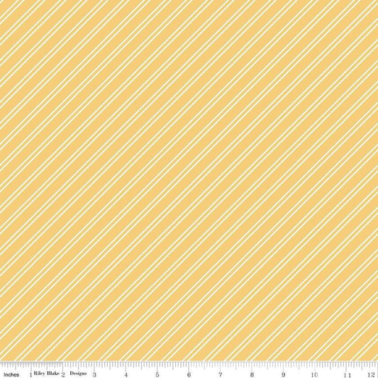 Image of the Between the Pages Stripes Honey quilting cotton fabric by Fran Gulick for Riley Blake Designs. Features diagonal small stripes on a light yellow background. 
Cute Little Fabric Shop