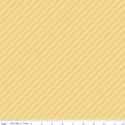 Image of the Between the Pages Stripes Honey quilting cotton fabric by Fran Gulick for Riley Blake Designs. Features diagonal small stripes on a light yellow background. 
Cute Little Fabric Shop
