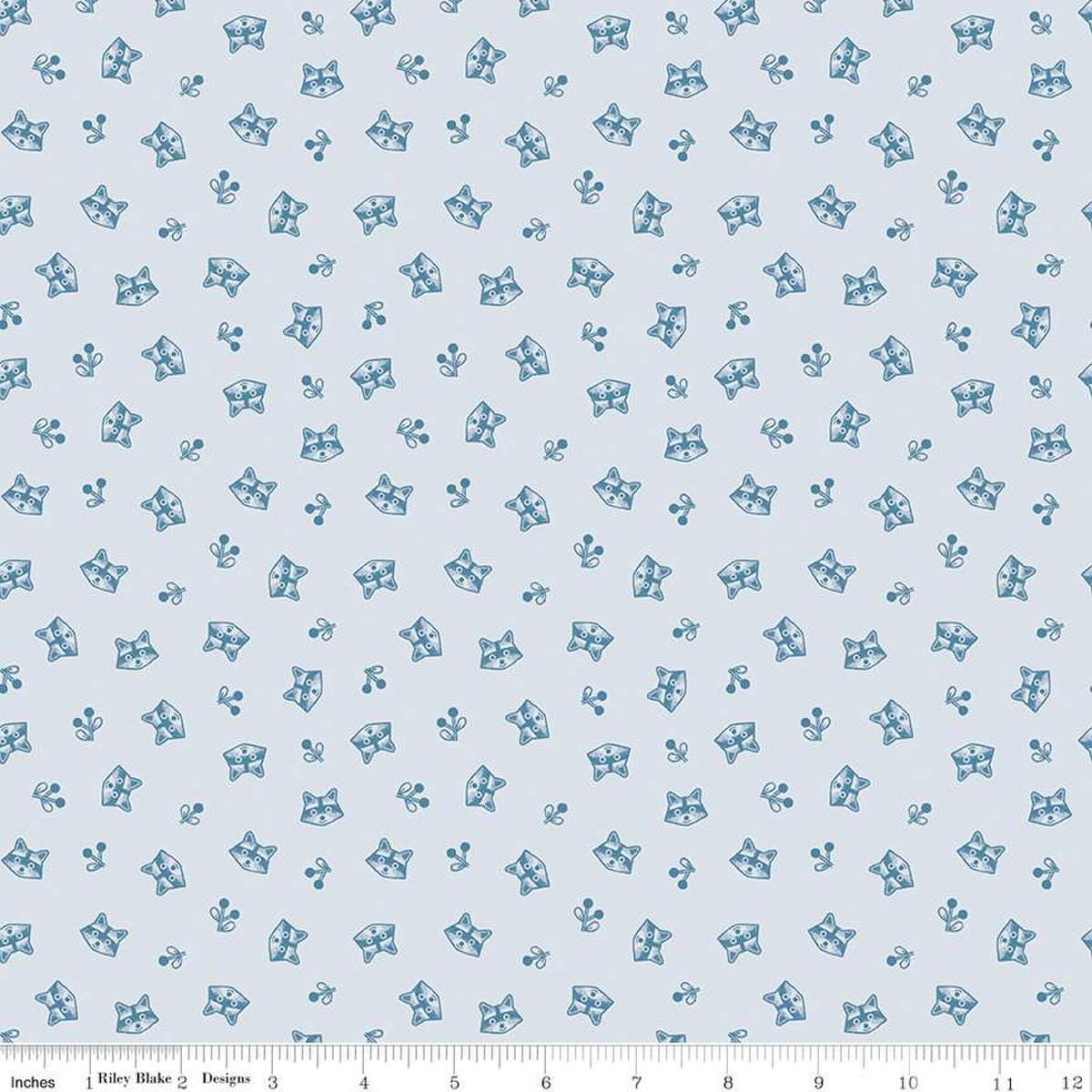 Image of the Twilight Creatures Raccoons Ice
 quilting cotton fabric by Natàlia Juan Abelló for Riley Blake Designs. Features scattered sprigs and raccoon heads on a pale blue background. 
Cute Little Fabric Shop