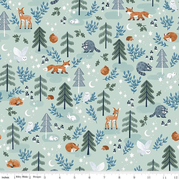 Image of the Twilight Creatures Main Mint
 quilting cotton fabric by Natàlia Juan Abelló for Riley Blake Designs. Features scattered trees, animals, stars, moons, and mushrooms on a pale green background. 
Cute Little Fabric Shop