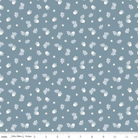 Image of the Twilight Creatures Happy Acorns Storm quilting cotton fabric by Natàlia Juan Abelló for Riley Blake Designs. Features small scattered acorns, stars, and leaves on a gray blue background. 
Cute Little Fabric Shop