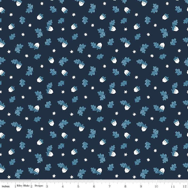 Image of the Twilight Creatures Happy Acorns Indigo quilting cotton fabric by Natàlia Juan Abelló for Riley Blake Designs. Features small scattered acorns, stars, and leaves on a dark blue background. 
Cute Little Fabric Shop