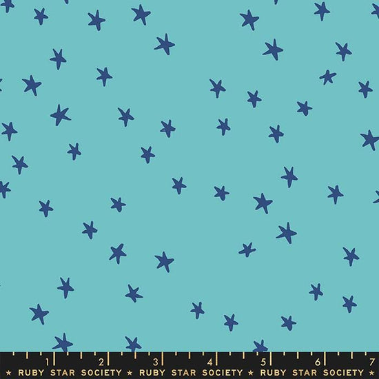 Image of the Starry Blenders Star Turquoise quilting cotton fabric by Alexia Abegg for Moda Fabrics. Features small scattered stars on a blue background. Cute Little Fabric Shop