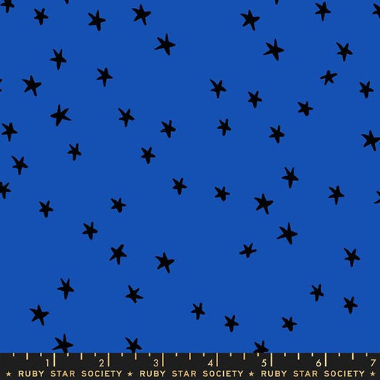 Image of the Starry Blenders Star Blue Ribbon quilting cotton fabric by Alexia Abegg for Moda Fabrics. Features small scattered stars on a blue background. Cute Little Fabric Shop