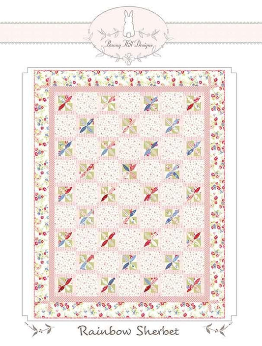 Image of the Rainbow Sherbet quilt pattern by Anne Sutton for Moda Fabrics. Features a quilt with pink and floral fabrics. 
Cute Little Fabric Shop