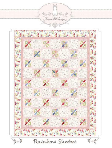 Image of the Rainbow Sherbet quilt pattern by Anne Sutton for Moda Fabrics. Features a quilt with pink and floral fabrics. 
Cute Little Fabric Shop