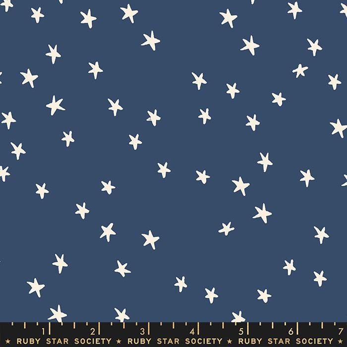 Image of the Starry Blenders Star Bluebell quilting cotton fabric by Alexia Abegg for Moda Fabrics. Features small scattered stars on a blue background. Cute Little Fabric Shop