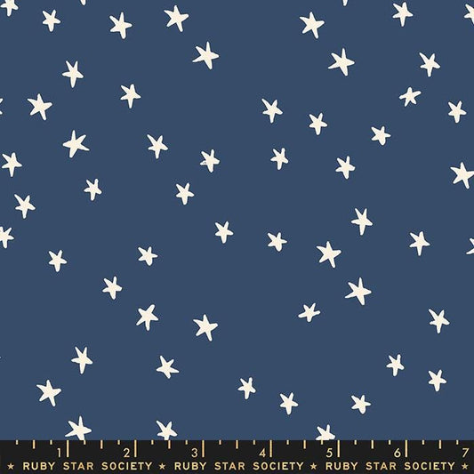Image of the Starry Blenders Star Bluebell quilting cotton fabric by Alexia Abegg for Moda Fabrics. Features small scattered stars on a blue background. Cute Little Fabric Shop