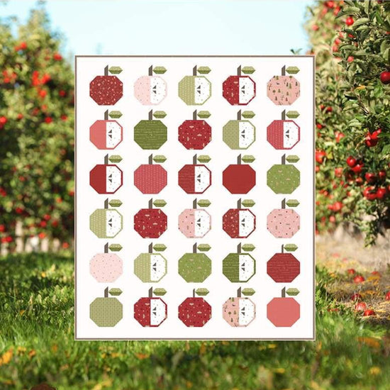 Image of the Apple Season Quilt Pattern by Jennifer Long for Riley Blake Designs. Features apples on a white background. 
Cute Little Fabric Shop