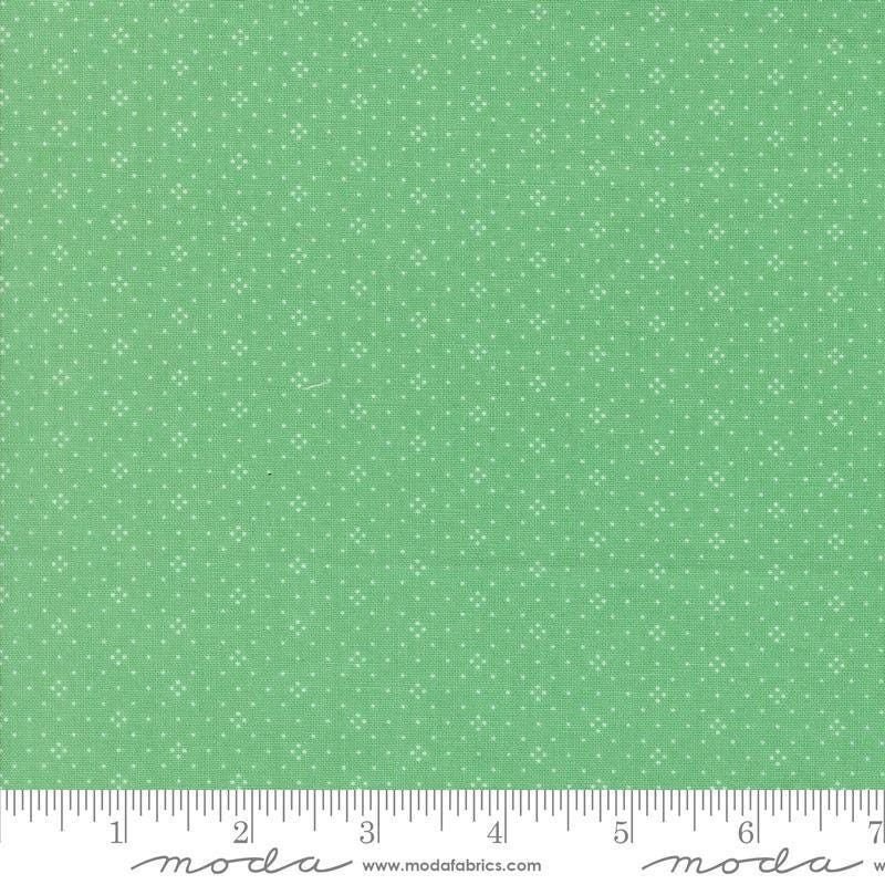 Image of the Portofino Eyelet Dots Azure quilting cotton fabric by Fig Tree Co for Riley Blake Designs. Features small circles on a green background. Cute Little Fabric Shop