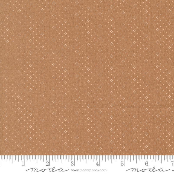 Image of the Portofino Eyelet Dots Sienna quilting cotton fabric by Fig Tree Co for Riley Blake Designs. Features small circles on a brown background. Cute Little Fabric Shop