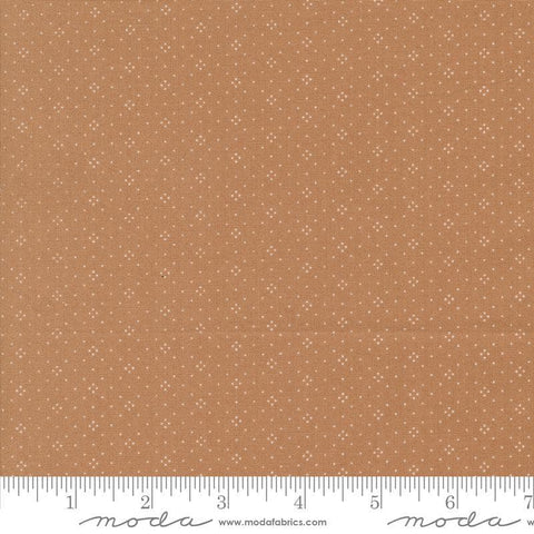 Image of the Portofino Eyelet Dots Sienna quilting cotton fabric by Fig Tree Co for Riley Blake Designs. Features small circles on a brown background. Cute Little Fabric Shop