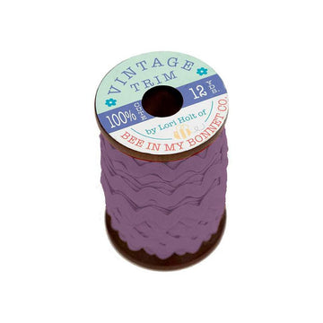 Image of the Vintage Trim Small Plum by Lori Holt for Riley Blake Designs. Features a purple trim on a small wooden spool. 
Cute Little Fabric Shop