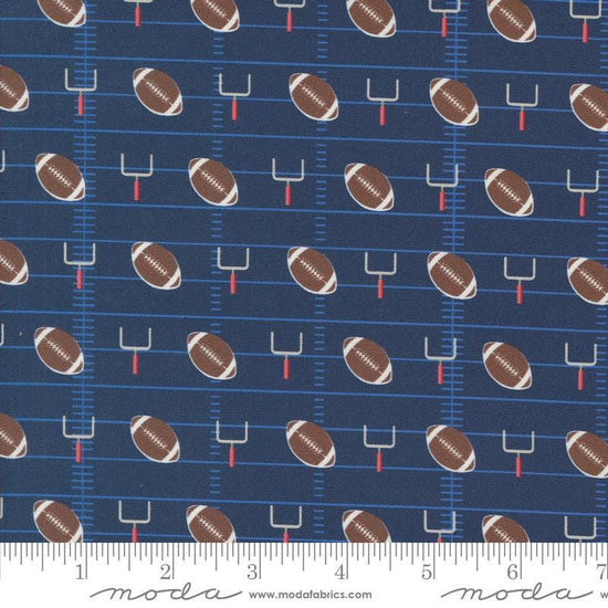 Image of the Play Ball Football Navy quilting cotton fabric by Moda Fabrics. Features novelty goal posts and footballs on a dark blue background. 
Cute Little Fabric Shop