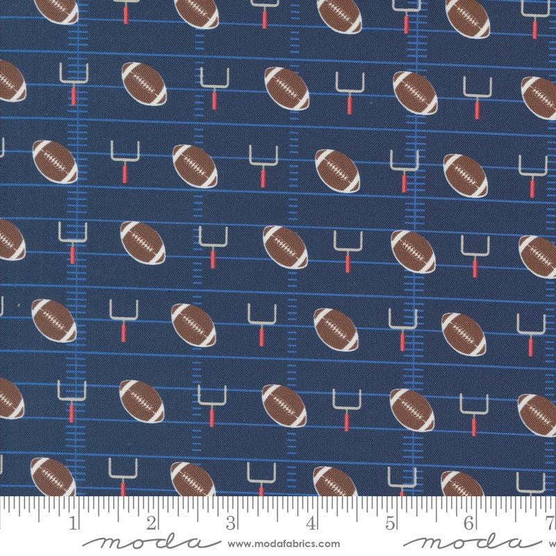 Image of the Play Ball Football Navy quilting cotton fabric by Moda Fabrics. Features novelty goal posts and footballs on a dark blue background. 
Cute Little Fabric Shop