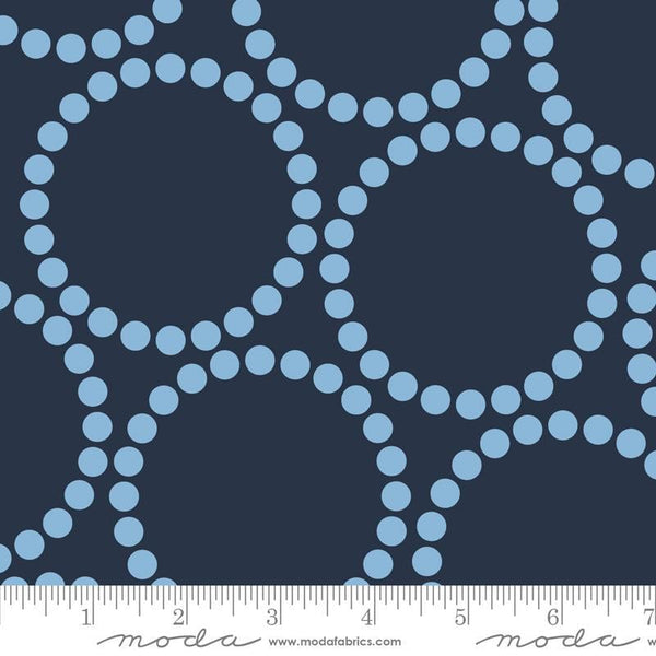 Image of the Pearl Bracelet Peacoat quilting cotton fabric by Lizzy House for Moda Fabrics. Features circles made up of small dots on a blue background. 
Cute Little Fabric Shop