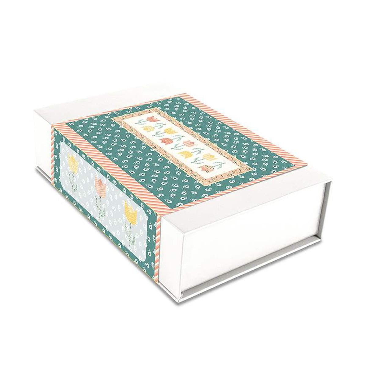 Image of the Tulip Festival Runner Boxed Kit by Sandy Gervais for Riley Blake Designs. Features flowers on a runner quilt. 
Cute Little Fabric Shop