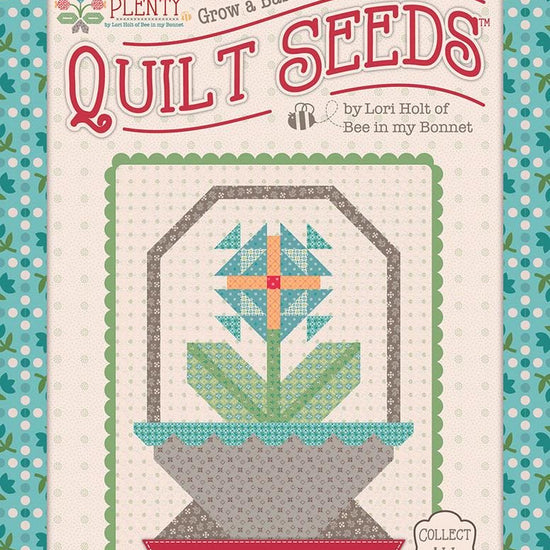 Image of the  Piece & Plenty Quilt Seeds™ Flower Basket No. 3 quilt pattern by Lori Holt for Riley Blake Designs. Features a blue flower on a quilt. 
Cute Little Fabric Shop
