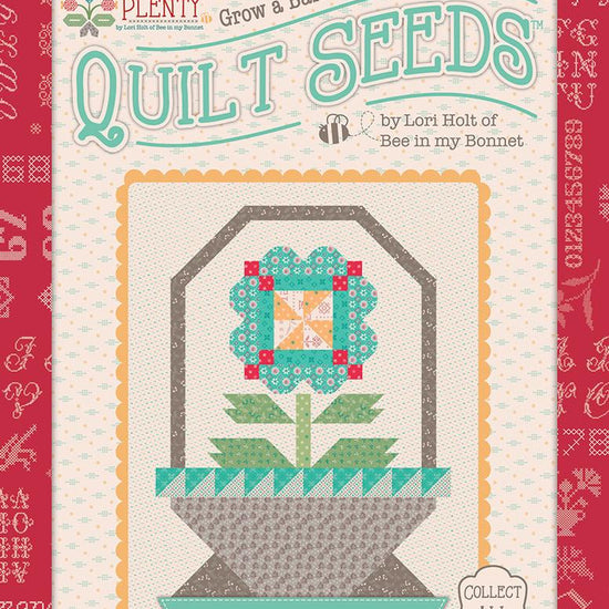 Image of the  Piece & Plenty Quilt Seeds™ Flower Basket No. 2 quilt pattern by Lori Holt for Riley Blake Designs. Features a blue flower on a quilt. 
Cute Little Fabric Shop