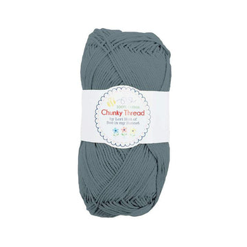 Image of the Chunky Thread Stonewash sport weight thread by Lori Holt for Riley Blake Designs. Features a muted blue thread. 
Cute Little Fabric Shop
