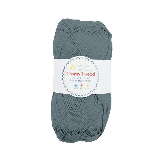 Image of the Chunky Thread Stonewash sport weight thread by Lori Holt for Riley Blake Designs. Features a muted blue thread. 
Cute Little Fabric Shop
