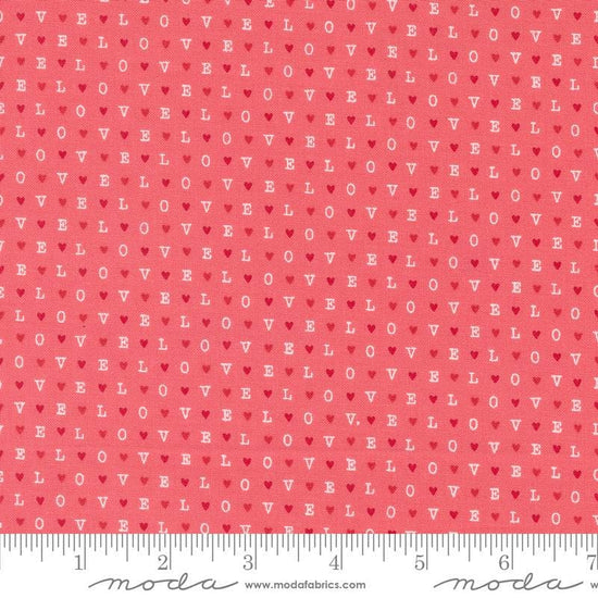 Image of the Love Blooms LOVE Lipstick quilting cotton fabric by Moda Fabrics. Features the word LOVE on a pink background. Cute Little Fabric Shop