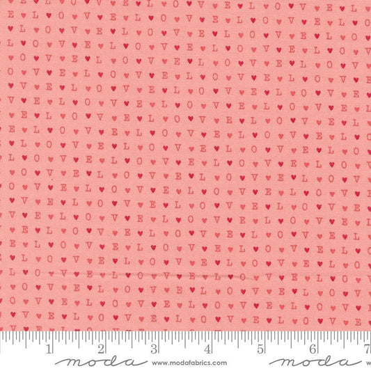 Image of the Love Blooms LOVE Blush quilting cotton fabric by Moda Fabrics. Features the word LOVE on a pink background. Cute Little Fabric Shop