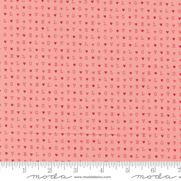 Image of the Love Blooms LOVE Blush quilting cotton fabric by Moda Fabrics. Features the word LOVE on a pink background. Cute Little Fabric Shop