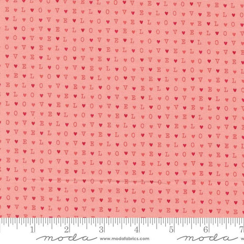 Image of the Love Blooms LOVE Blush quilting cotton fabric by Moda Fabrics. Features the word LOVE on a pink background. Cute Little Fabric Shop