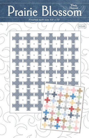 Image of the Prairie Blossom quilt pattern by Wendy Sheppard for Riley Blake Designs. Features star patterns on a quilt. 
Cute Little Fabric Shop