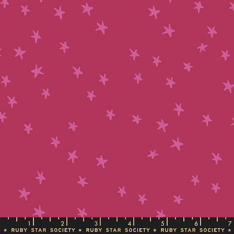 Image of the Starry Blenders Star Plum quilting cotton fabric by Alexia Abegg for Moda Fabrics. Features small scattered stars on a dark pink background. Cute Little Fabric Shop