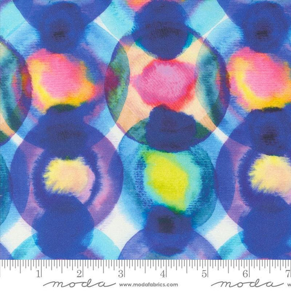Image of the Flower Patches Orbs Prism quilting cotton fabric by Amarilys Henderson for Moda Fabrics. Features orbs on a blue background. Cute Little Fabric Shop