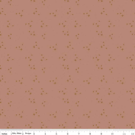 Blush 'n Butterscotch Cross Sparkles Dusty quilting cotton fabric by Simple Simon & Company for Riley Blake Designs. Features small sparkle crosses on a pink background. Cute Little Fabric Shop