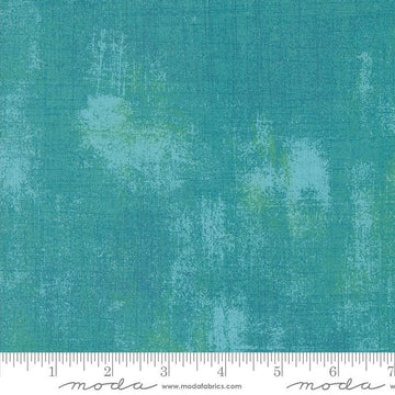 Image of the Sunday Brunch Grunge Basics Mint Tea quilting cotton fabric by Moda Fabrics. Features a textured pattern on a teal background. Cute Little Fabric Shop