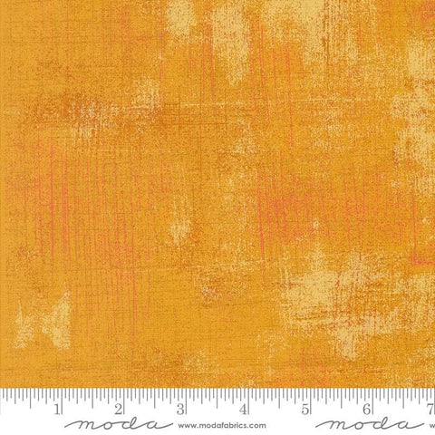 Image of the Sunday Brunch Grunge Basics OJ quilting cotton fabric by Moda Fabrics. Features a textured pattern on an orange background. Cute Little Fabric Shop