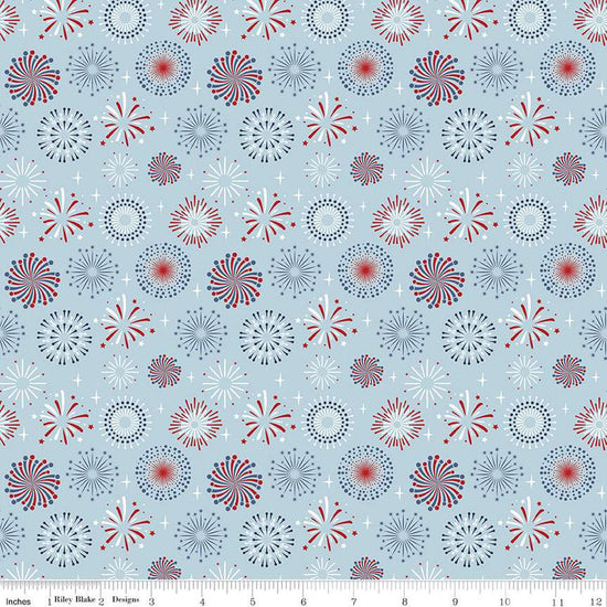 Image of the Stars and Stripes Forever Fireworks Sky quilting cotton fabric by Lori Whitlock for Riley Blake Designs. Features fireworks on a blue background. Cute Little Fabric Shop