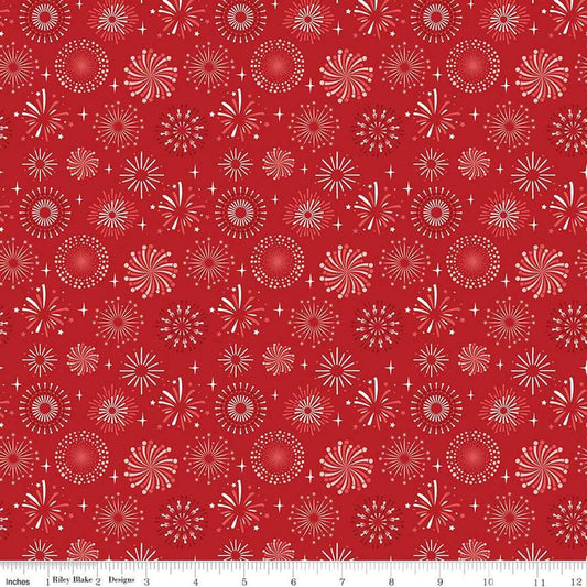 Image of the Stars and Stripes Forever Fireworks Red quilting cotton fabric by Lori Whitlock for Riley Blake Designs. Features fireworks on a red background. Cute Little Fabric Shop