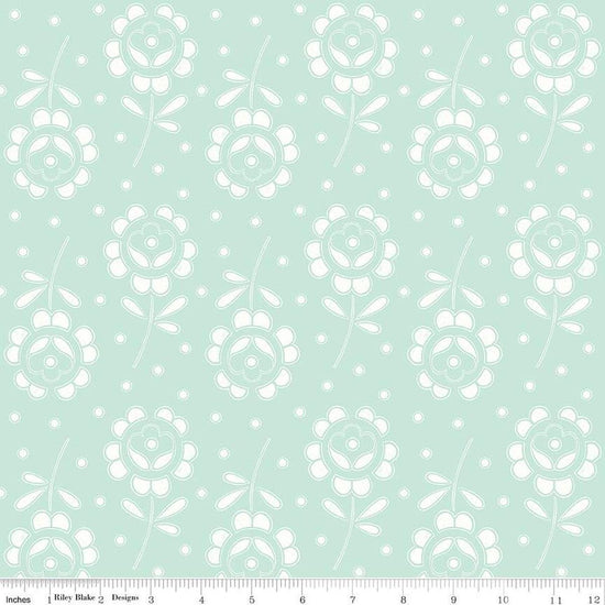Image of the Sewing Seeds III Rose Cutwork Aqua quilting cotton fabric by Lori Holt for Riley Blake Designs. Features flowers on a pink background. Cute Little Fabric Shop