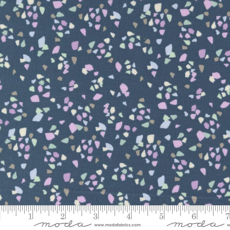 Image of the Seaglass Summer Pebble Indigo Sea quilting cotton fabric by Moda Fabrics. Features shapes on a navy blue background. Cute Little Fabric Shop