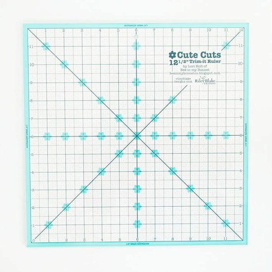 Image of the Lori Holt Cute Cuts™ Trim-it™ Ruler 12 1/2" x 12 1/2" by Riley Blake Designs. Features a large clear ruler. 
Cute Little Fabric Shop