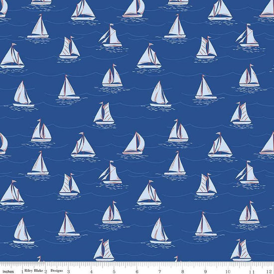 Image of the Yacht Club Sailboats Blue quilting cotton fabric by Amanda Niederhauser for Riley Blake Designs. Features boats on a blue background. Cute Little Fabric Shop