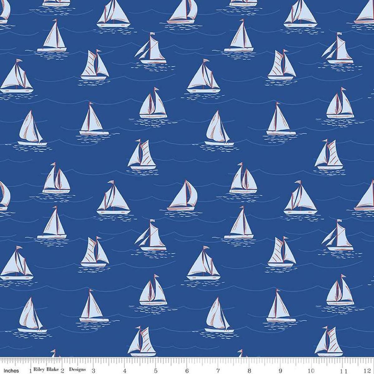 Image of the Yacht Club Sailboats Blue quilting cotton fabric by Amanda Niederhauser for Riley Blake Designs. Features boats on a blue background. Cute Little Fabric Shop